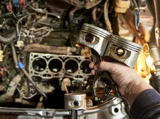 A person working on a diesel engine.